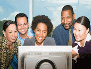 Group of business people looking at a computer monitor
