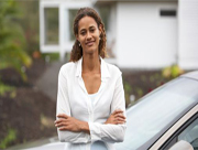 Photo of woman standing next to a car
